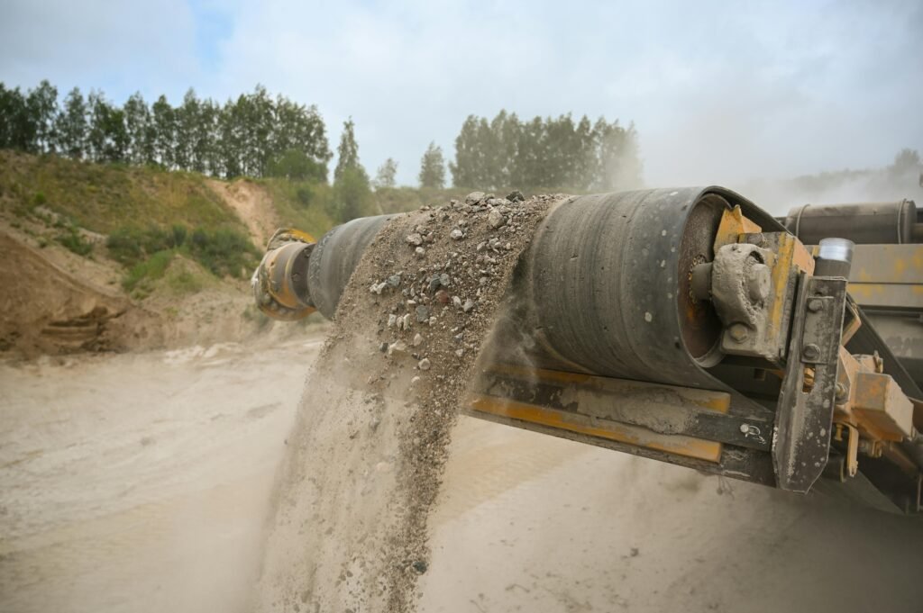 pexels photo 17320030 17320030 A close-up of an industrial conveyor belt moving gravel at a construction site